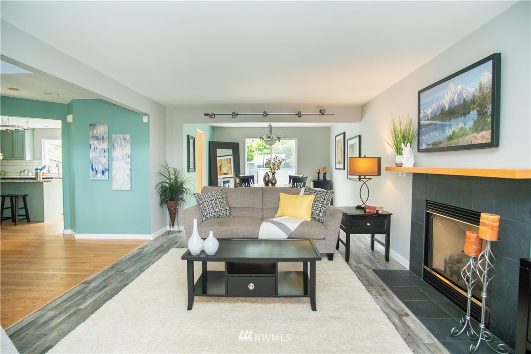 7215 South Rustic Road Seattle, WA 98178 - Photo 8 of 32 a living room with fireplace furniture and a flat screen tv