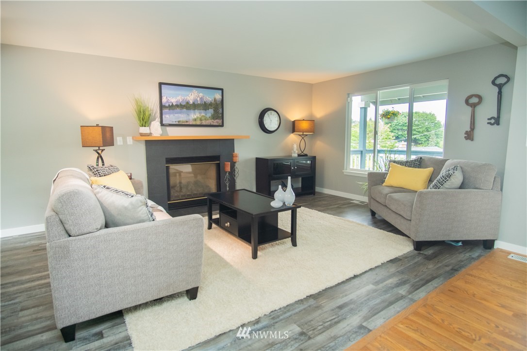 7215 South Rustic Road Seattle, WA 98178 - Photo 10 of 32 a living room with furniture and a fireplace