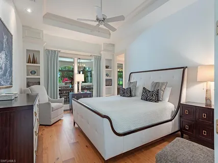 a bedroom with a large bed and a chandelier