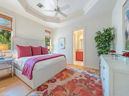 a bedroom with bed and a potted plant