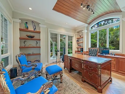 a room with furniture pool table and a large window