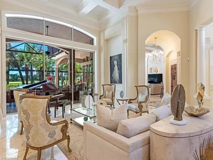 a living room with furniture a fireplace and a large window
