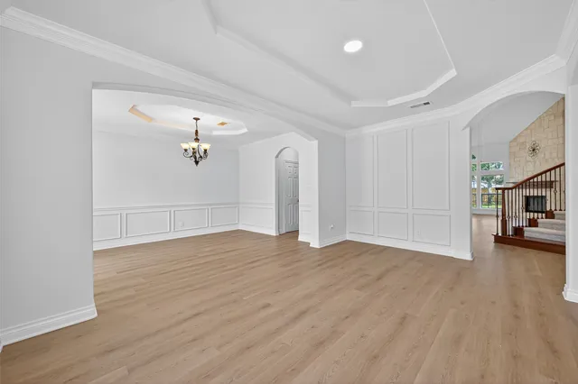 a view of a livingroom with wooden floor and a ceiling fan