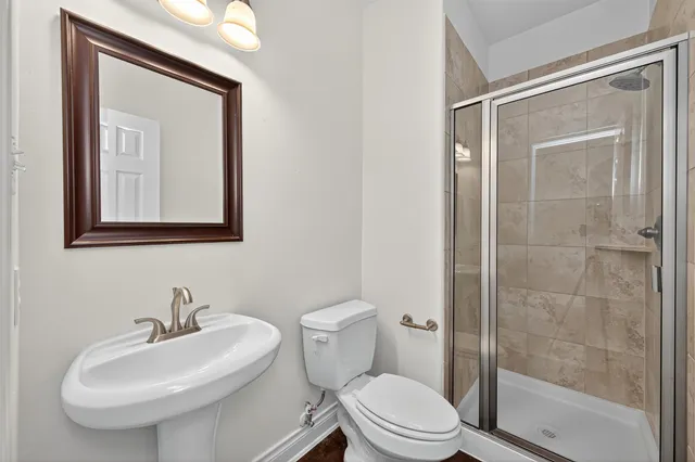 a bathroom with a toilet a sink and a mirror