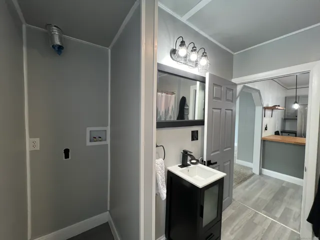 a kitchen with a refrigerator a sink and chairs