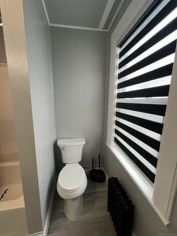 a white toilet sitting next to a sink