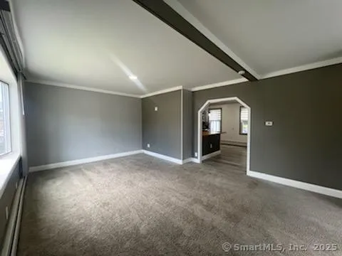 an empty room with closet and mirror