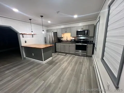 a kitchen with stainless steel appliances a refrigerator sink and cabinets
