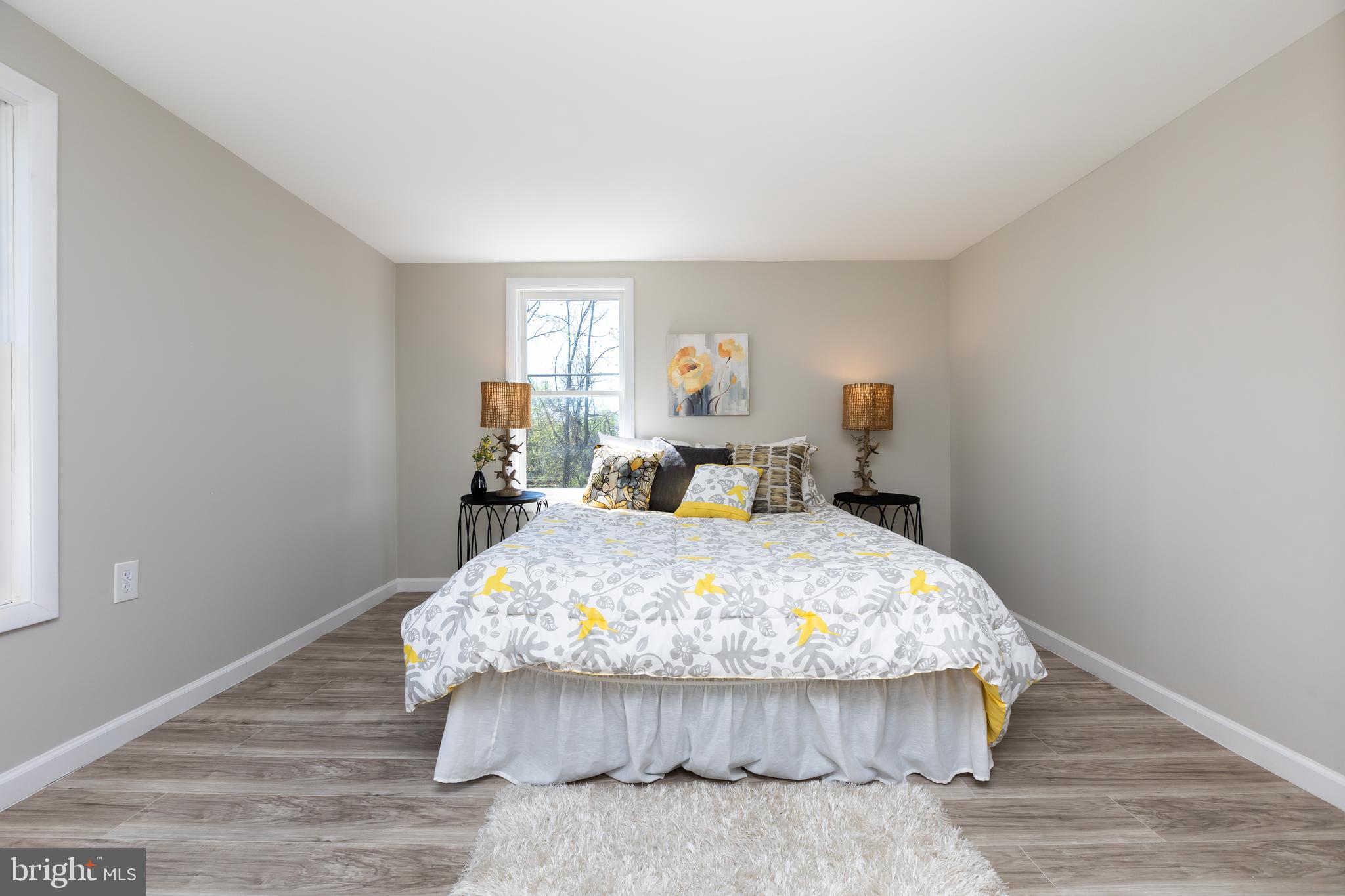 2407 Hammonds Ferry Road Halethorpe, MD 21227 - Photo 24 of 43 a bedroom with a bed and wooden floor