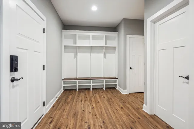 a view of a room with wooden floor and white walls