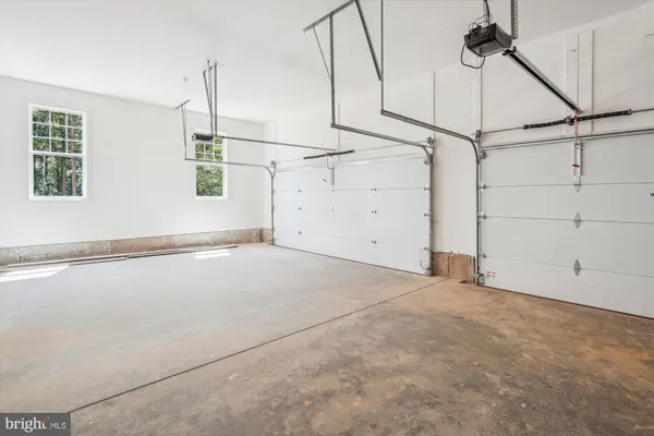 an empty room with a ceiling fan and a window