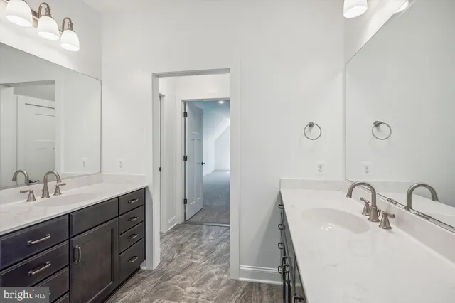 a bathroom with a double vanity sink and mirror
