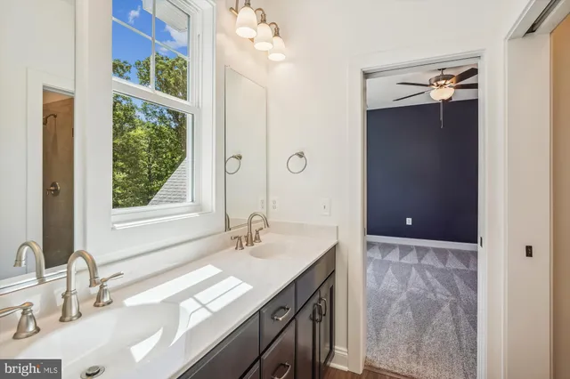a bathroom with a sink double vanity and a mirror