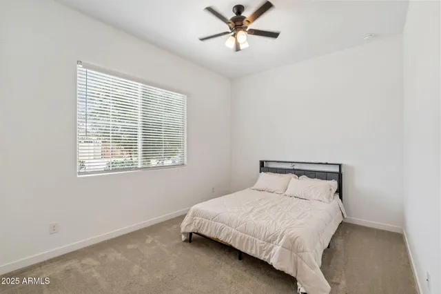 a bedroom with a bed and window