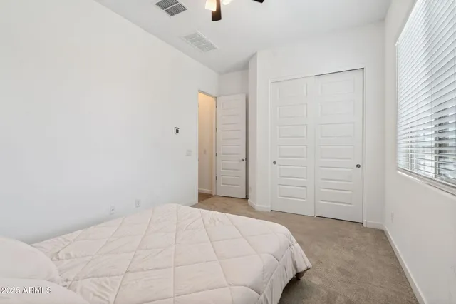 a bedroom with a bed and a window