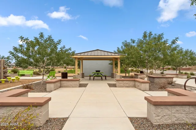 a view of a house with backyard and sitting area