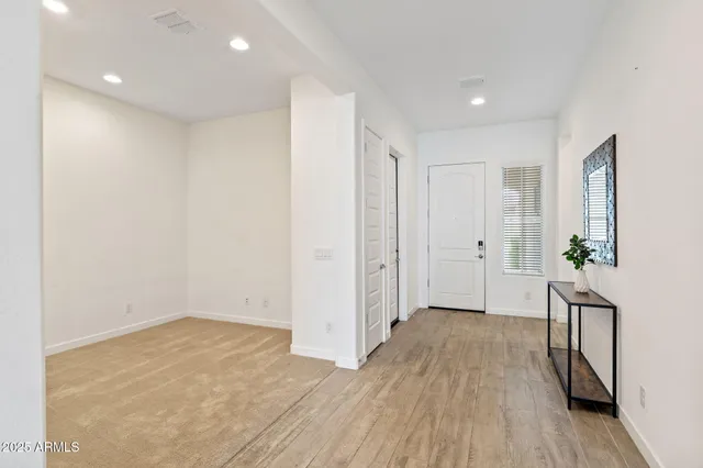 a view of hallway with wooden floor