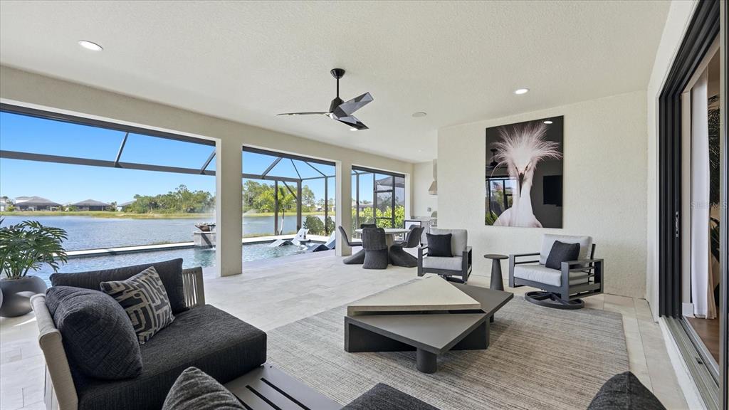 12866 Pinnacle Lane Venice, FL 34293 - Photo 16 of 96 a living room with furniture fireplace and a large window