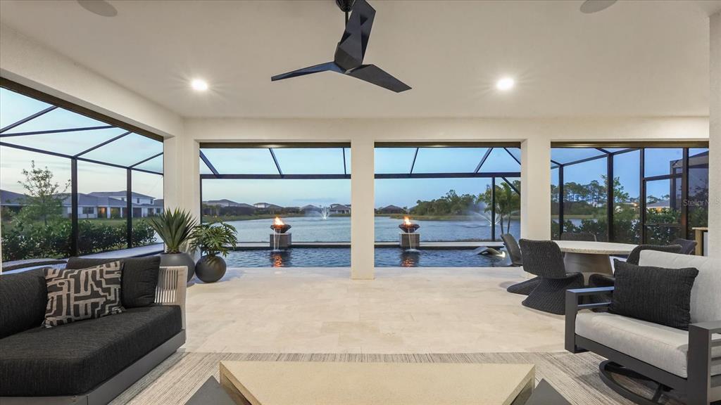 12866 Pinnacle Lane Venice, FL 34293 - Photo 17 of 96 a living room with patio furniture and a floor to ceiling window