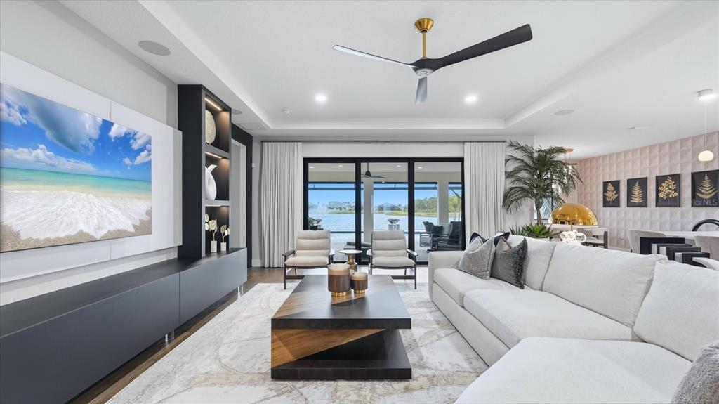 12866 Pinnacle Lane Venice, FL 34293 - Photo 28 of 96 a living room with furniture large window and flat screen tv