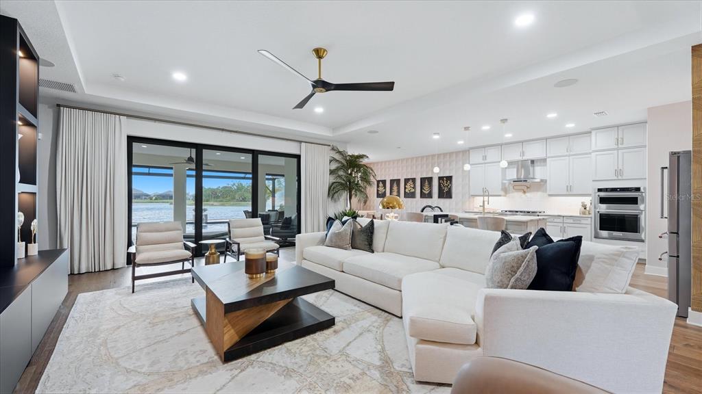 12866 Pinnacle Lane Venice, FL 34293 - Photo 29 of 96 a living room with furniture and a large window