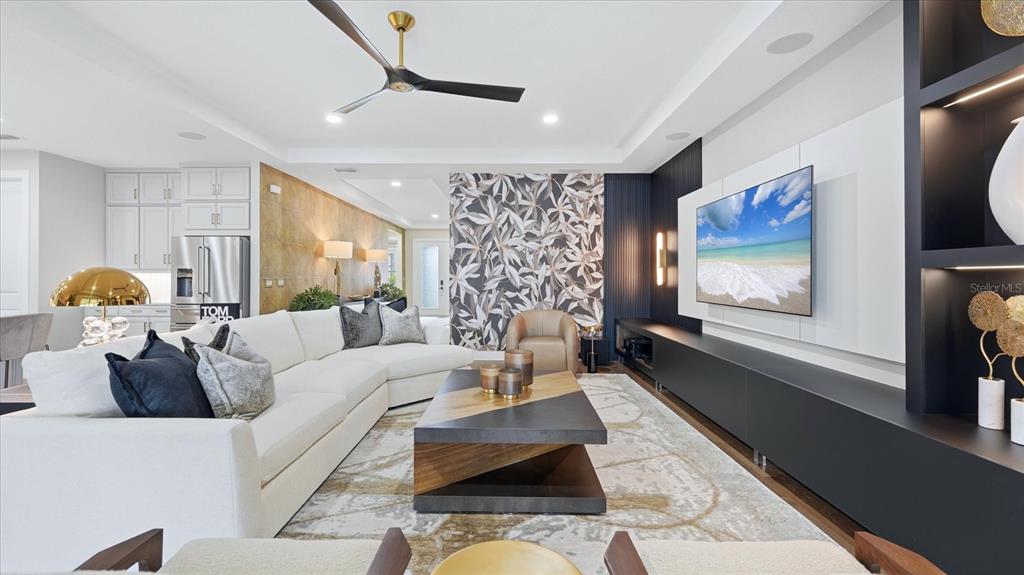 12866 Pinnacle Lane Venice, FL 34293 - Photo 32 of 96 a living room with furniture and a flat screen tv