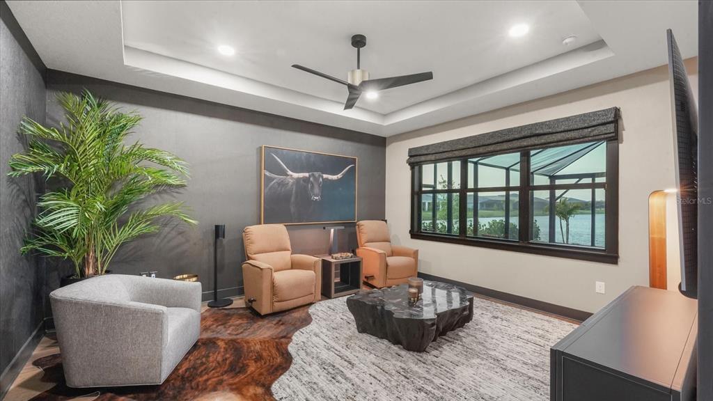 12866 Pinnacle Lane Venice, FL 34293 - Photo 38 of 96 a living room with furniture a potted plant and a chandelier