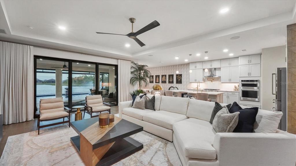 12866 Pinnacle Lane Venice, FL 34293 - Photo 39 of 96 a living room with furniture and a large window