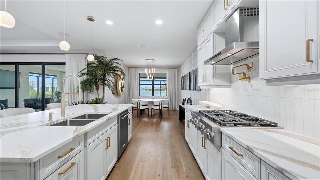 12866 Pinnacle Lane Venice, FL 34293 - Photo 41 of 96 a kitchen with stainless steel appliances a sink a stove and cabinets