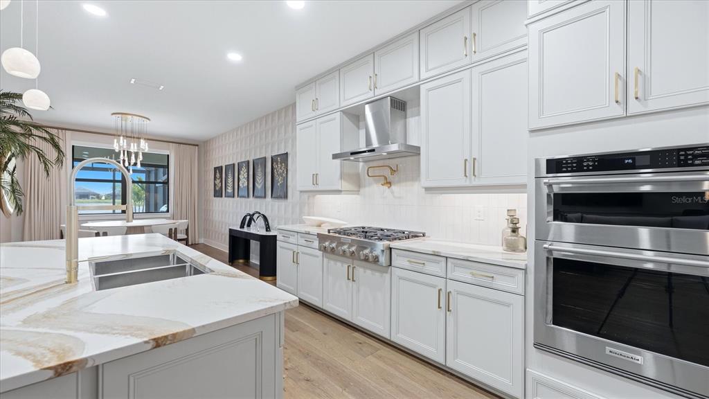 12866 Pinnacle Lane Venice, FL 34293 - Photo 42 of 96 a kitchen with stainless steel appliances granite countertop a stove and a sink