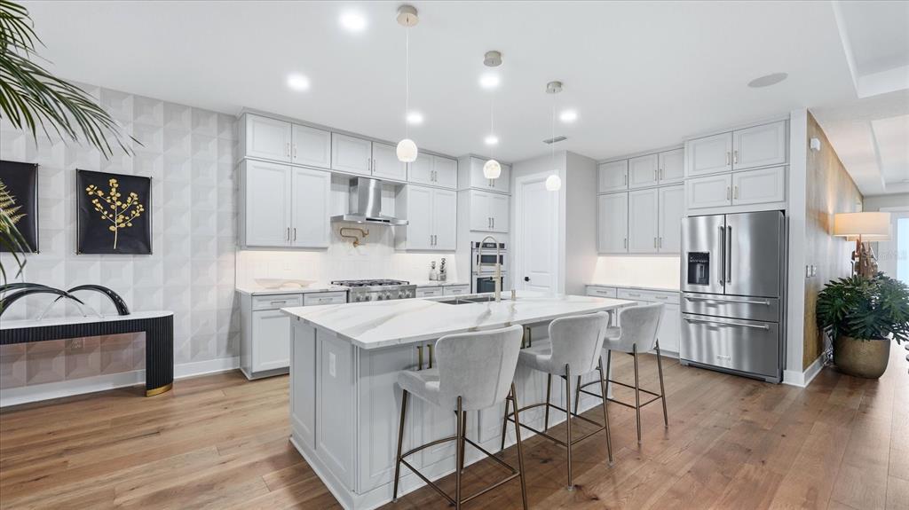 12866 Pinnacle Lane Venice, FL 34293 - Photo 45 of 96 a kitchen with white cabinets and stainless steel appliances