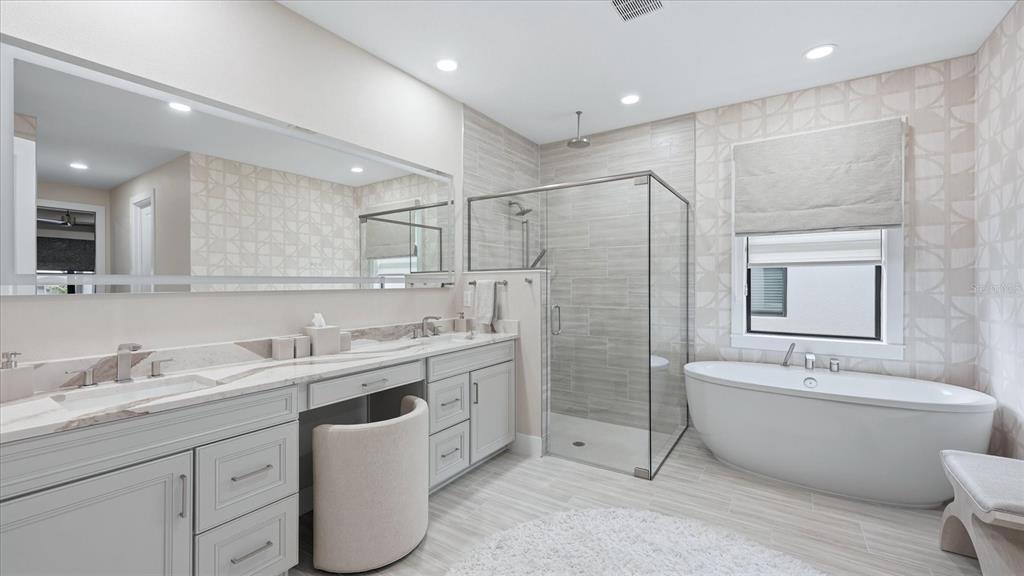 12866 Pinnacle Lane Venice, FL 34293 - Photo 55 of 96 a bathroom with a double vanity sink mirror and bathtub