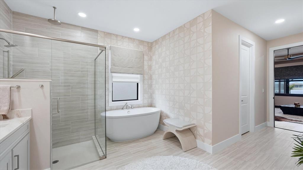 12866 Pinnacle Lane Venice, FL 34293 - Photo 56 of 96 a spacious bathroom with a toilet a sink and a bathtub