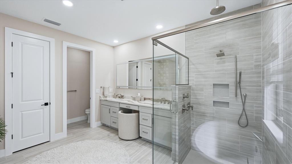 12866 Pinnacle Lane Venice, FL 34293 - Photo 57 of 96 a bathroom with a granite countertop sink a mirror and shower