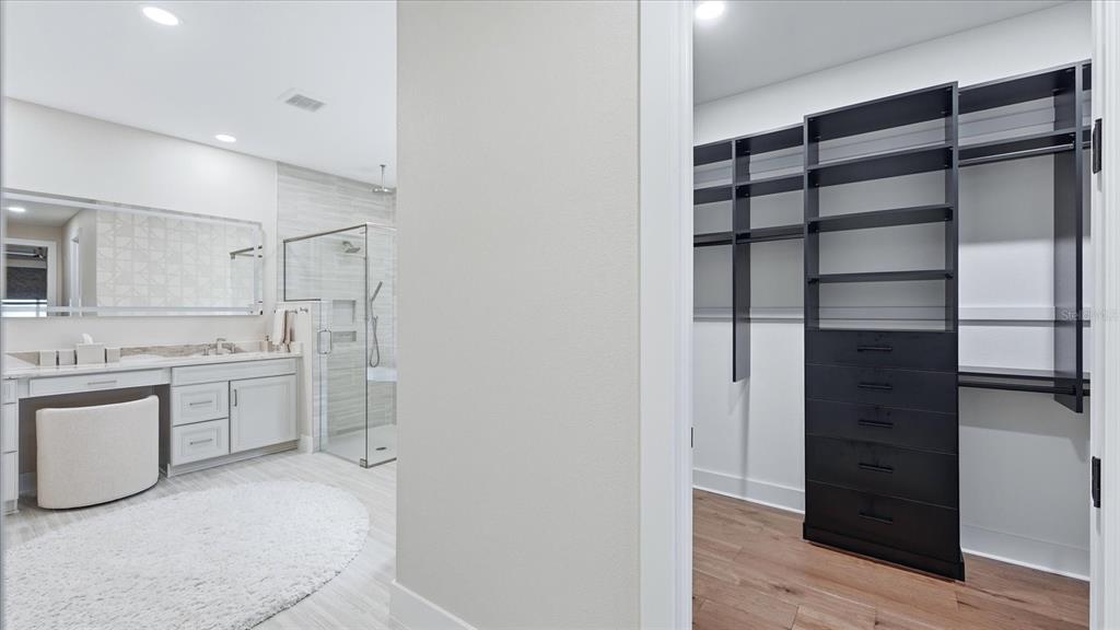 12866 Pinnacle Lane Venice, FL 34293 - Photo 58 of 96 a kitchen with a refrigerator and white cabinets