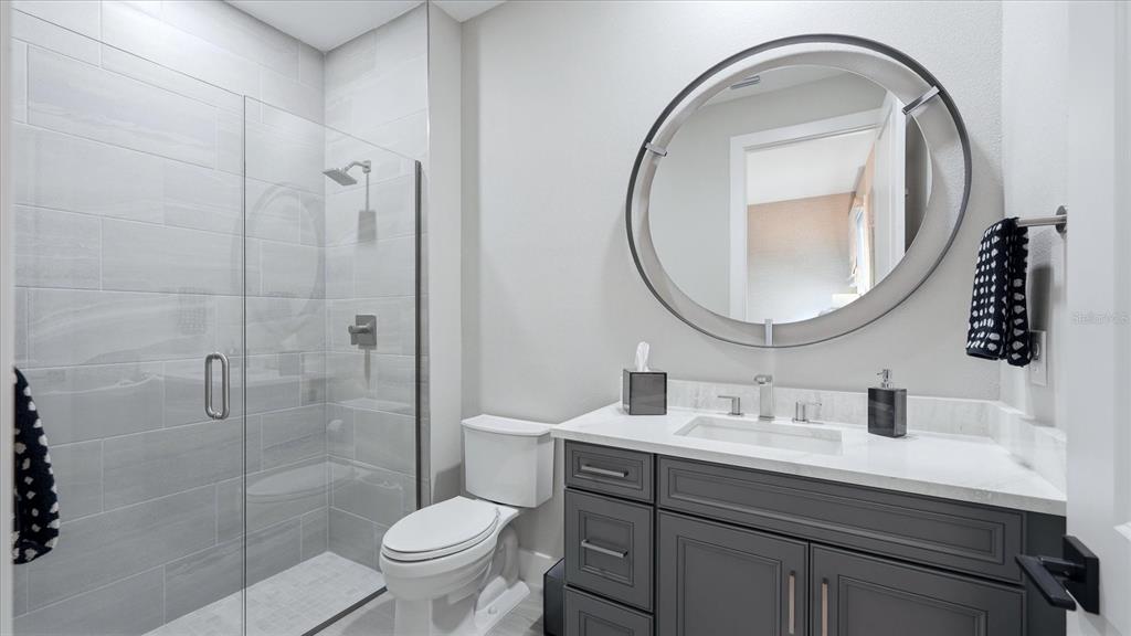 12866 Pinnacle Lane Venice, FL 34293 - Photo 61 of 96 a bathroom with a sink a toilet and a mirror