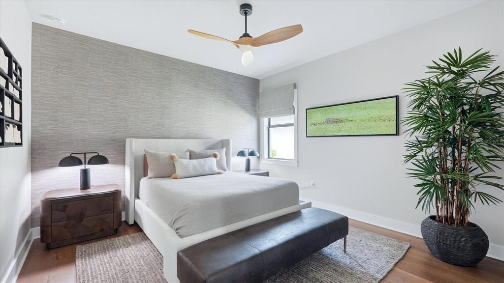 12866 Pinnacle Lane Venice, FL 34293 - Photo 63 of 96 a bedroom with a bed a couch and a potted plant