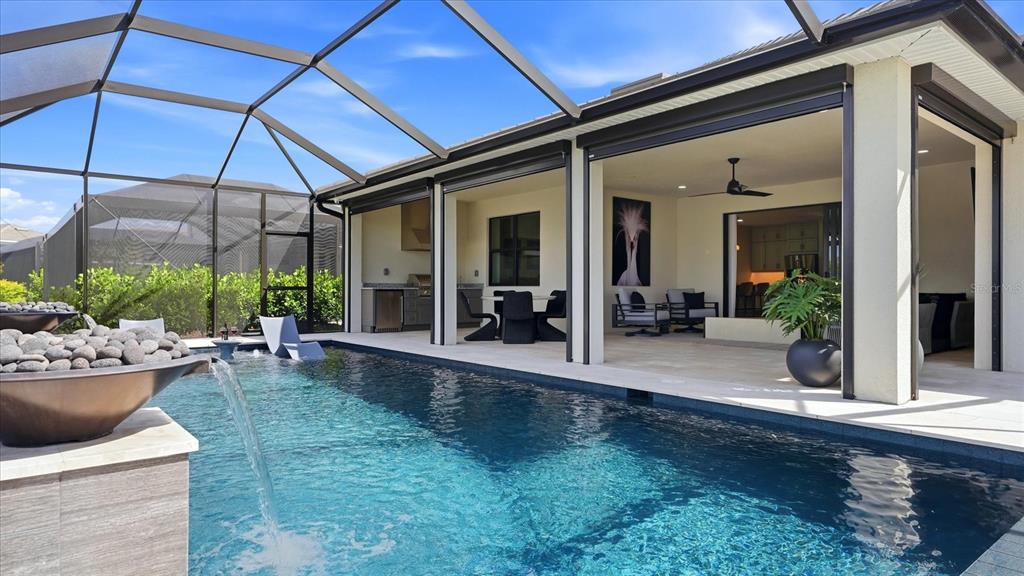 12866 Pinnacle Lane Venice, FL 34293 - Photo 68 of 96 a view of a house with backyard sitting area and garden