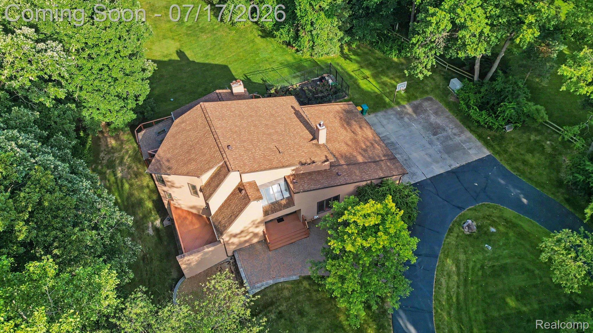 5685 Paint Valley Drive Rochester, MI 48306 - Photo 48 of 66 Terracotta-toned residential structure featuring multiple rooflines and a prominent chimney