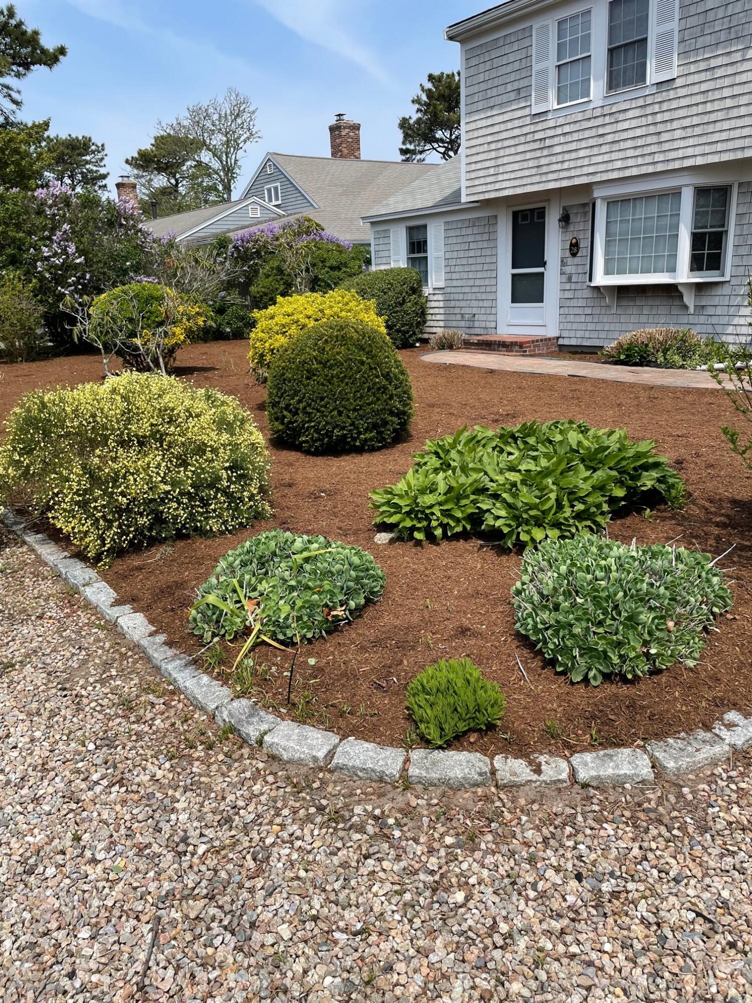 28 Santucket Road West Dennis, MA 02670 - Photo 13 of 23 a front view of a house with a yard and garage