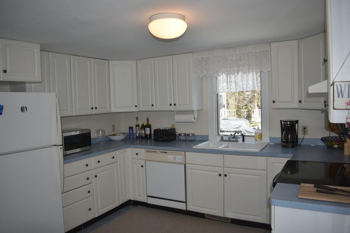 28 Santucket Road West Dennis, MA 02670 - Photo 3 of 23 a kitchen with cabinets appliances and a sink