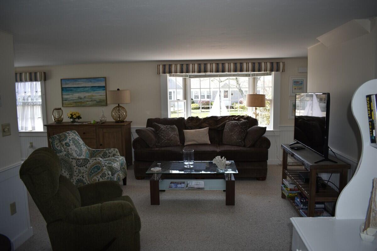 28 Santucket Road West Dennis, MA 02670 - Photo 6 of 23 a living room with furniture and a flat screen tv