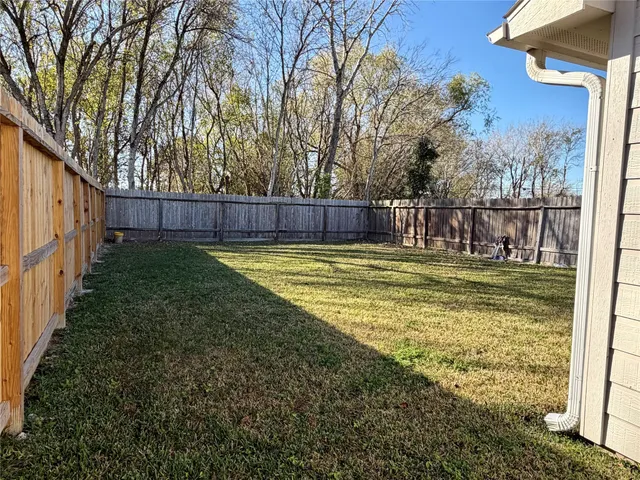 a swimming pool with some trees in the background