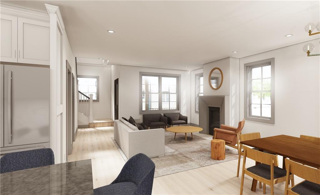 558 Mifflin Avenue Pittsburgh, PA 15221 - Photo 2 of 6 a living room with furniture a fireplace and a large window