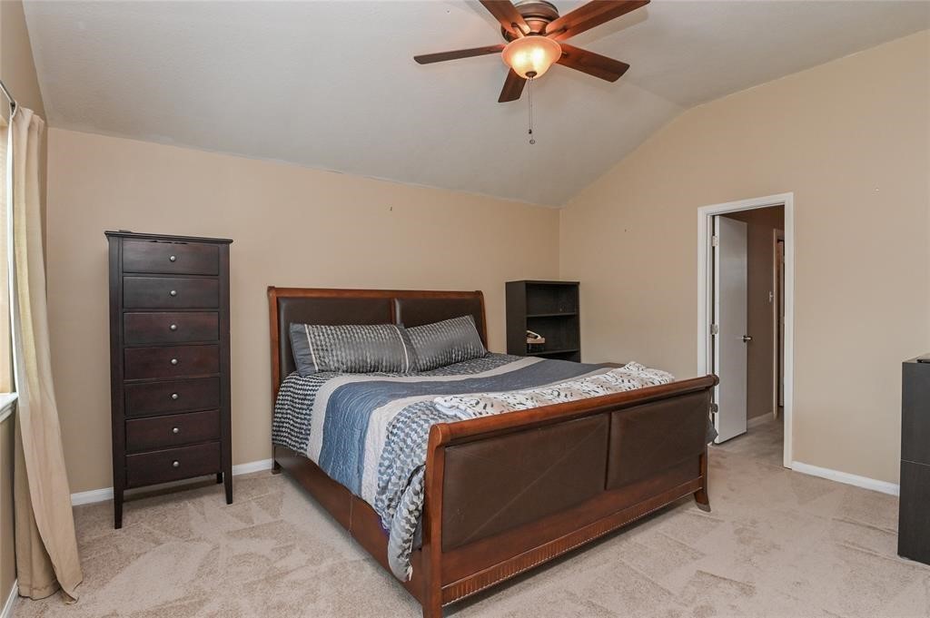 18446 South Wimbledon Drive Katy, TX 77449 - Photo 20 of 24 a bedroom with a bed and a chandelier