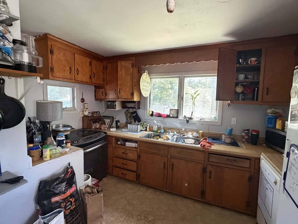 42 Birch Road Westford, MA 01886 - Photo 8 of 10 a kitchen with a sink a stove a window cabinetry and kitchen appliances