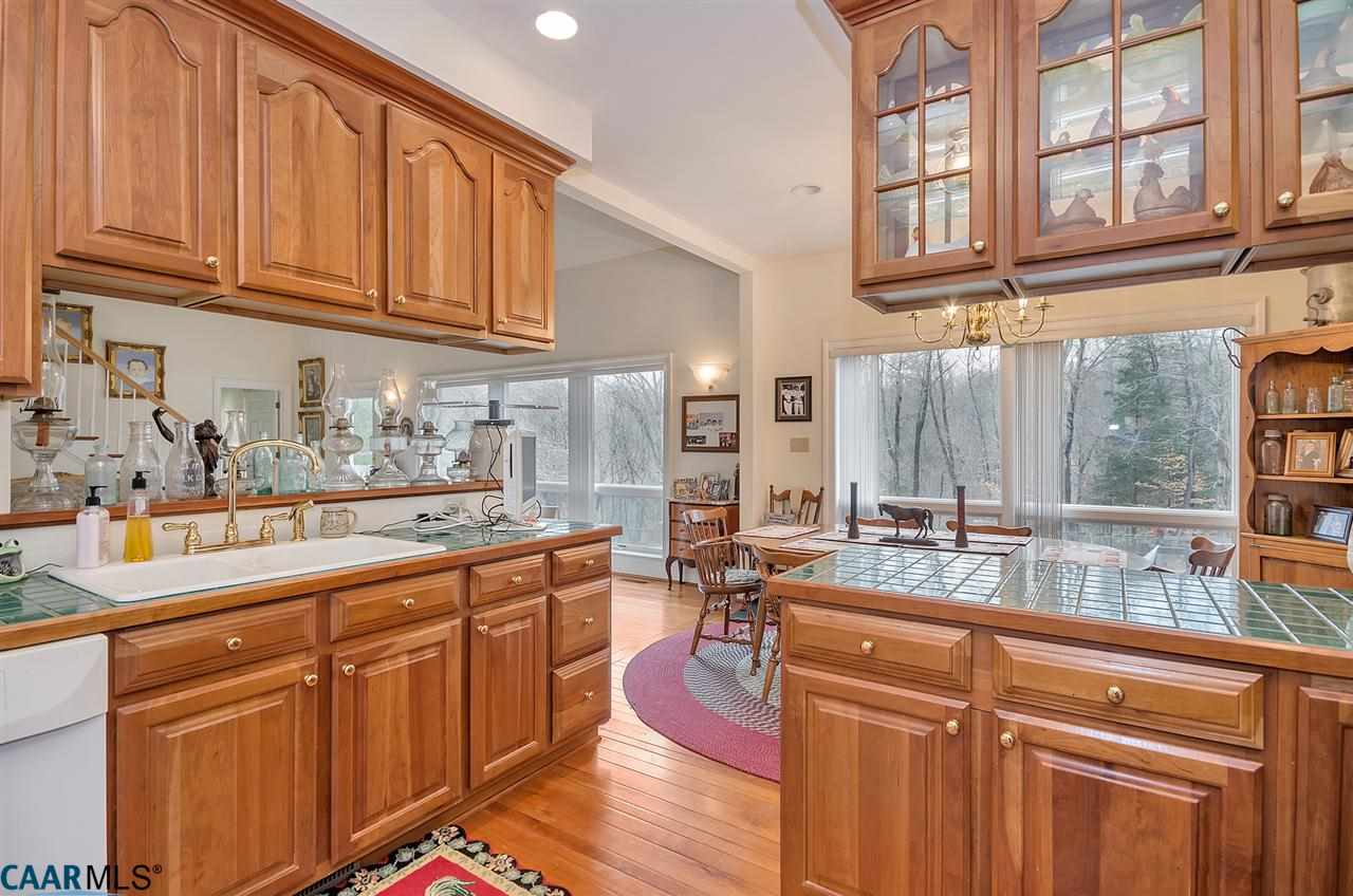 3895 Jacks Shop Road Rochelle, VA 22738 - Photo 9 of 41 a kitchen with stainless steel appliances granite countertop a sink dishwasher stove and cabinets with wooden floor