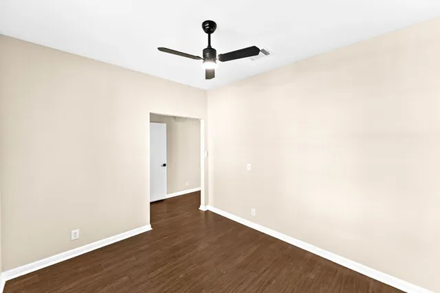 a view of a room with wooden floor