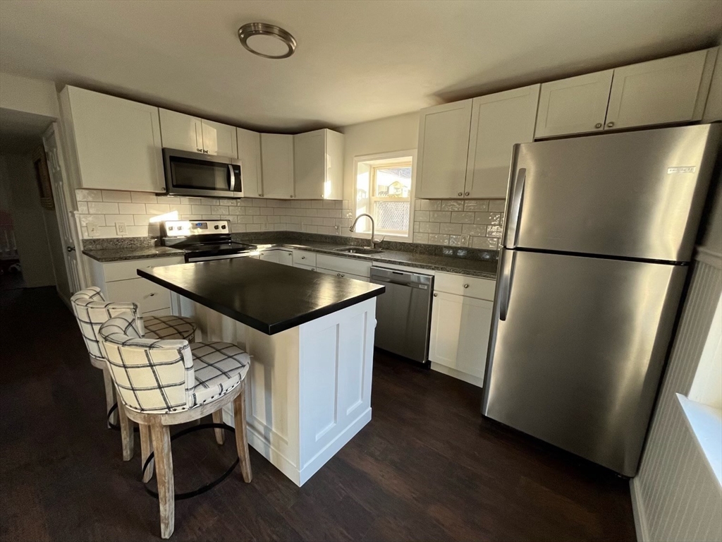37 Tyson Road Worcester, MA 01606 - Photo 5 of 18 a kitchen with stainless steel appliances a refrigerator a sink a stove a microwave a sink and a refrigerator