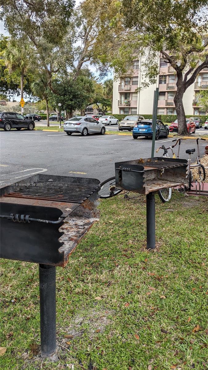 2701 Riverside Drive, Unit 206B Coral Springs, FL 33065 - Photo 11 of 19 a swimming pool with outdoor seating and yard